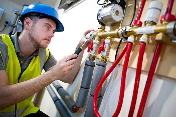 engineer installing underfloor heating system